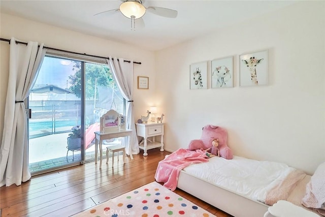 bedroom featuring a ceiling fan, wood finished floors, and access to exterior