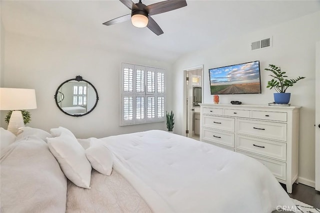 bedroom featuring visible vents, a ceiling fan, baseboards, and wood finished floors