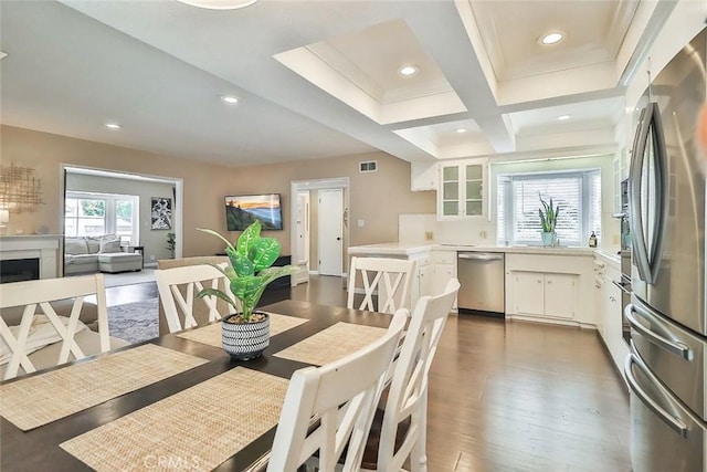dining room with visible vents, crown molding, wood finished floors, beam ceiling, and recessed lighting
