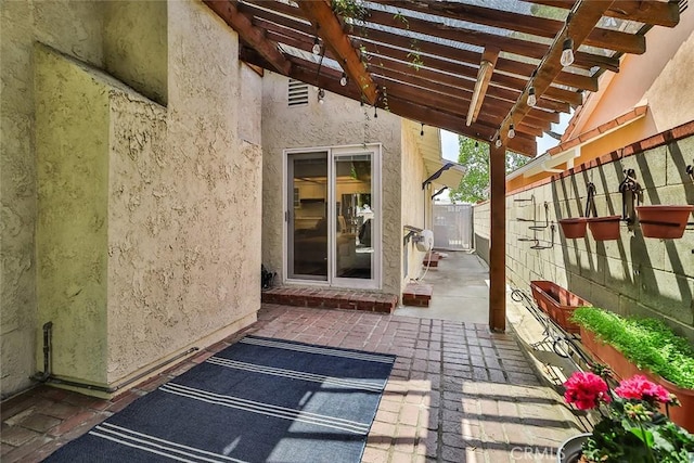 view of patio featuring fence and a pergola