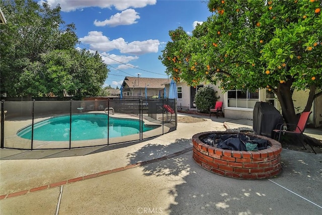 view of pool featuring a fenced in pool, fence, a patio, and a fire pit