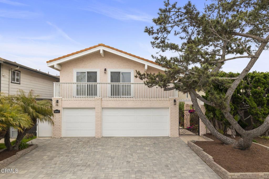 view of front of home with a garage, stucco siding, and decorative driveway