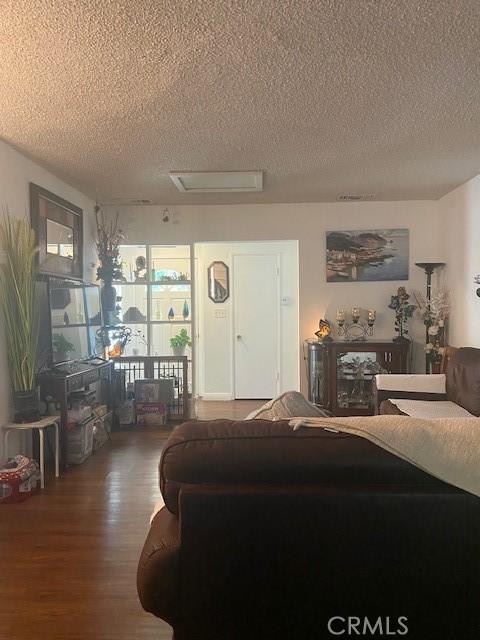 20243 Bassett St, Winnetka, CA 91306 - living room with a textured ceiling, attic access, and wood finished floors