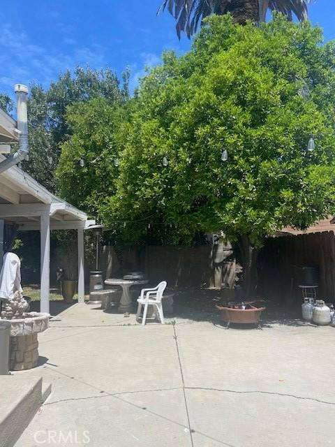 20243 Bassett St, Winnetka, CA 91306 - view of patio / terrace with a fire pit and fence