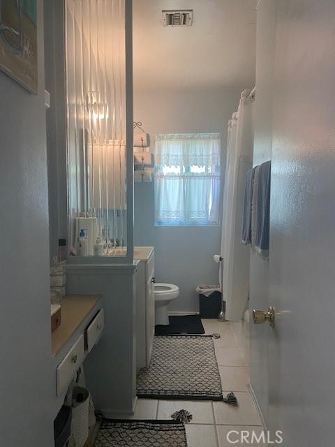 20243 Bassett St, Winnetka, CA 91306 - full bathroom featuring toilet, tile patterned floors, and a shower with curtain