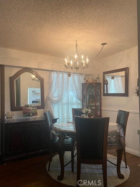 20243 Bassett St, Winnetka, CA 91306 - dining room with a chandelier, a textured ceiling, and wood finished floors