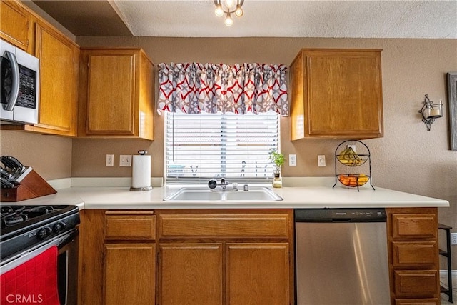 510 Monika Ct, Beaumont, CA 92223 - kitchen featuring light countertops, a sink, brown cabinets, and stainless steel appliances