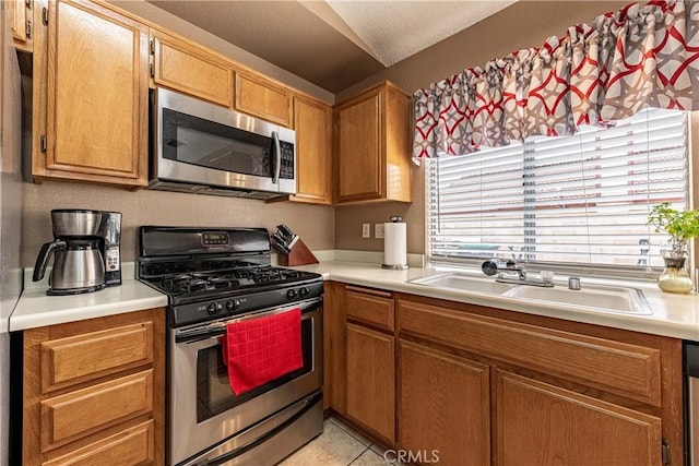 510 Monika Ct, Beaumont, CA 92223 - kitchen with a sink, appliances with stainless steel finishes, brown cabinetry, and light countertops