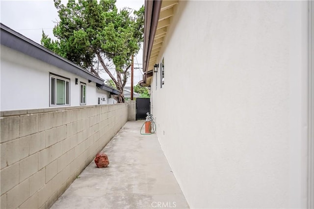 16840 Superior St, Northridge, CA 91343 - view of side of property featuring stucco siding, fence, and a patio