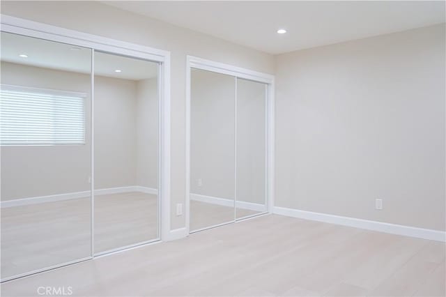 16840 Superior St, Northridge, CA 91343 - unfurnished bedroom featuring multiple closets, recessed lighting, wood finished floors, and baseboards