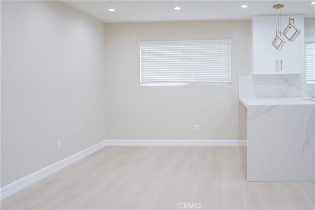 16840 Superior St, Northridge, CA 91343 - unfurnished dining area with light wood finished floors, baseboards, and recessed lighting