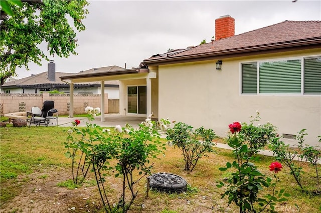 16840 Superior St, Northridge, CA 91343 - back of house featuring an outdoor fire pit, a patio, a chimney, and stucco siding