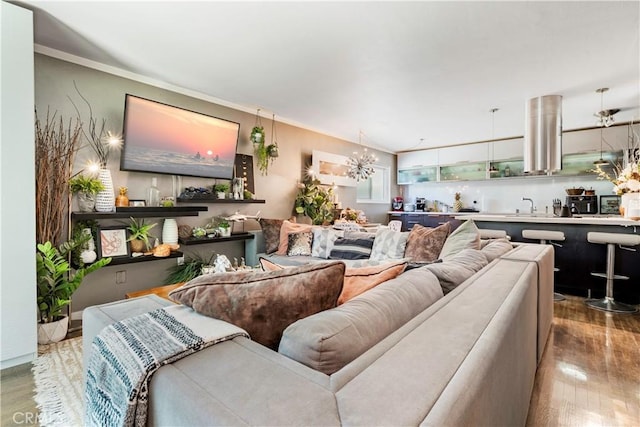 360 Obispo Ave Unit 15, Long Beach, CA 90814 - living room featuring wood finished floors, a chandelier, and ornamental molding