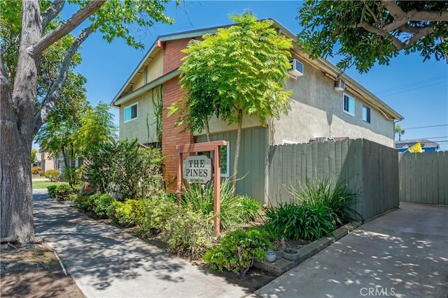 360 Obispo Ave Unit 15, Long Beach, CA 90814 - view of property exterior with stucco siding and a wall unit AC