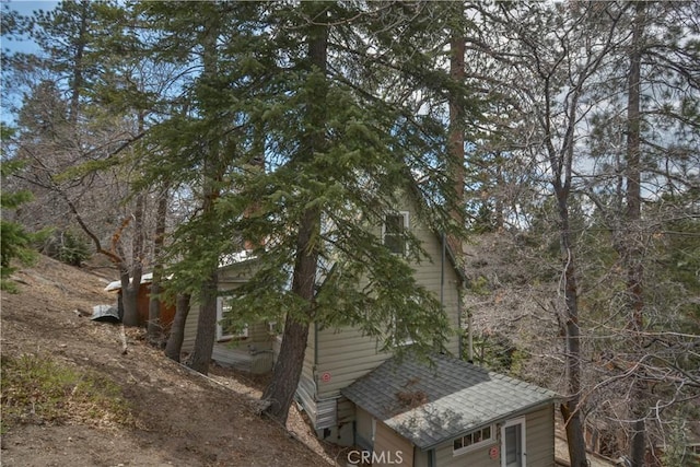 view of side of property with a shingled roof
