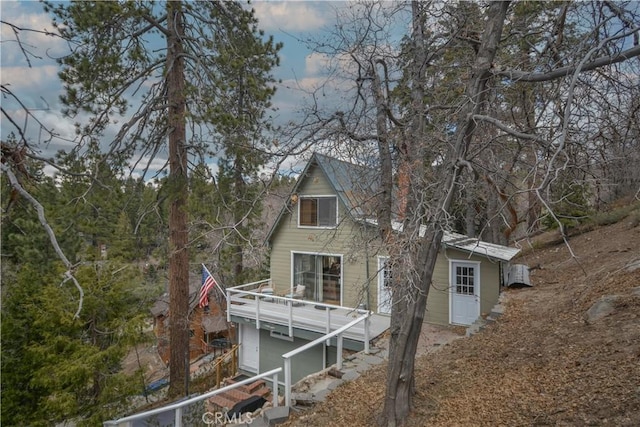 rear view of property featuring a balcony
