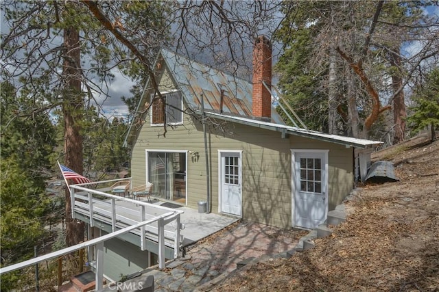 rear view of property with a chimney