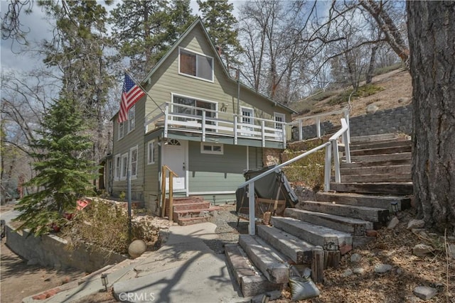 rear view of house featuring stairway