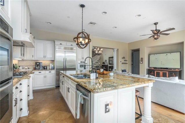 4027 W Hemlock St, Oxnard, CA 93035 - kitchen with a sink, stainless steel appliances, open floor plan, decorative backsplash, and ceiling fan
