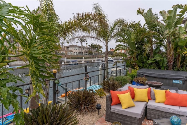 balcony featuring a water view, a dock, and an outdoor hangout area