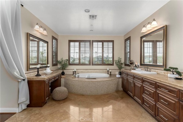 full bath with tile patterned floors, visible vents, a garden tub, and vanity
