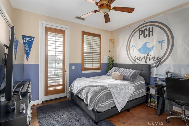 bedroom featuring visible vents, ceiling fan, wood finished floors, and access to outside
