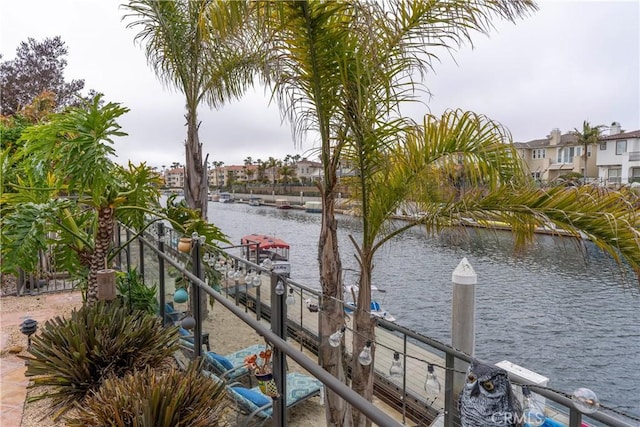dock area with boat lift and a water view