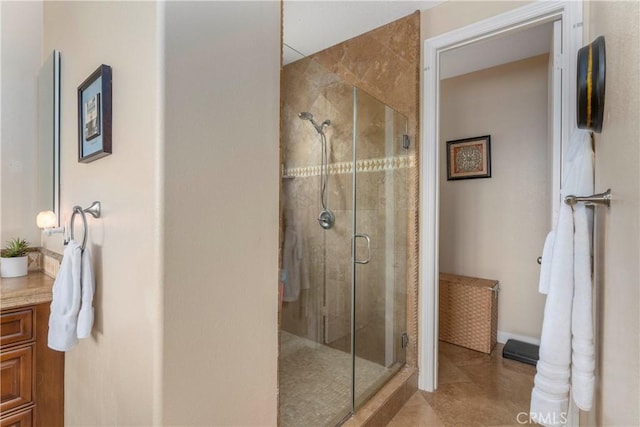 full bath featuring vanity, tile patterned floors, and a shower stall