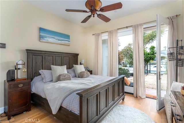 bedroom featuring access to outside, ceiling fan, and light wood-style flooring