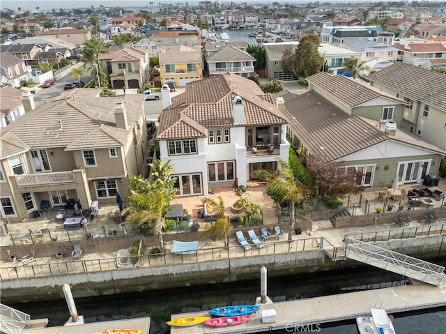 drone / aerial view featuring a water view and a residential view
