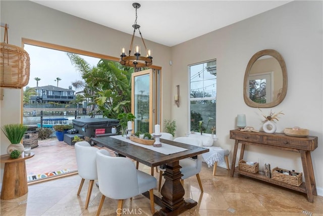 tiled dining space with an inviting chandelier