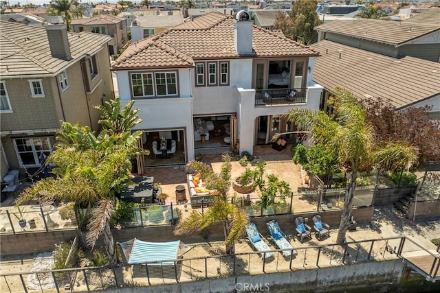 4027 W Hemlock St, Oxnard, CA 93035 - rear view of property with a balcony, a fenced backyard, a tile roof, stucco siding, and a patio area