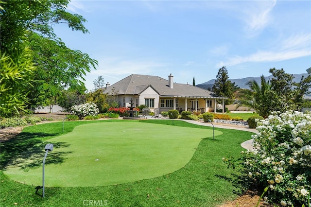 955 Union St, Cherry Valley, CA 92223 - rear view of property featuring a putting green, a mountain view, and a chimney