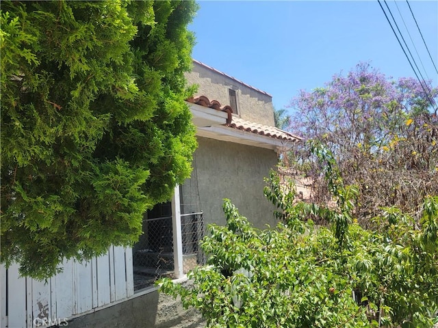 view of side of property featuring fence