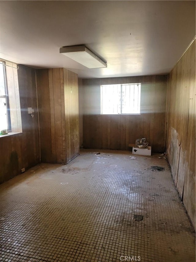 spare room featuring wooden walls