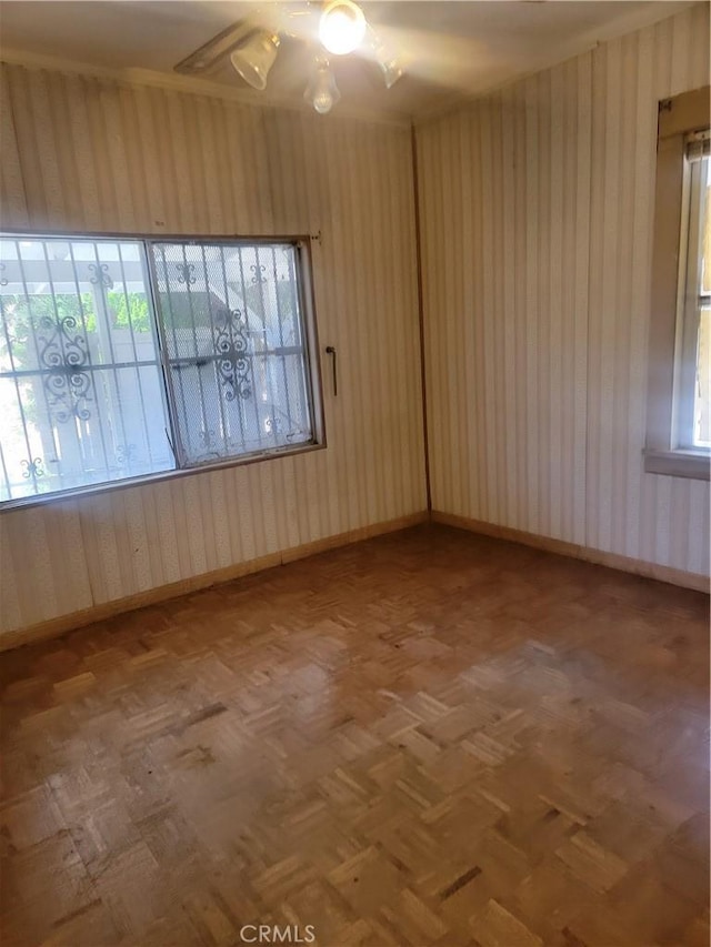 empty room featuring baseboards and a ceiling fan