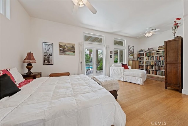 54030 Eisenhower Dr, La Quinta, CA 92253 - bedroom featuring access to exterior, wood finished floors, french doors, and ceiling fan