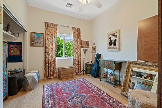 54030 Eisenhower Dr, La Quinta, CA 92253 - sitting room featuring ceiling fan, wood finished floors, and baseboards