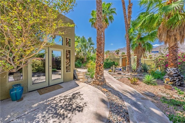 54030 Eisenhower Dr, La Quinta, CA 92253 - property entrance featuring french doors and stucco siding