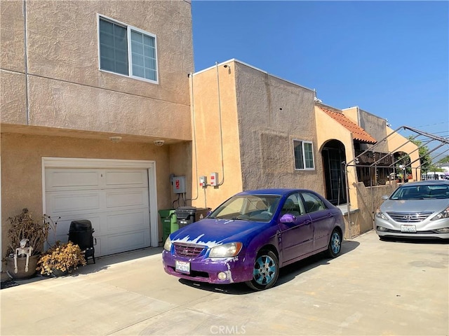 view of front of home with concrete driveway and stucco siding