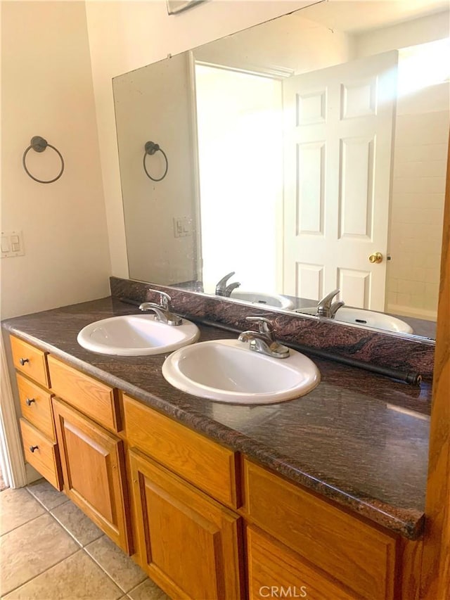 bathroom featuring a sink, tile patterned flooring, and double vanity