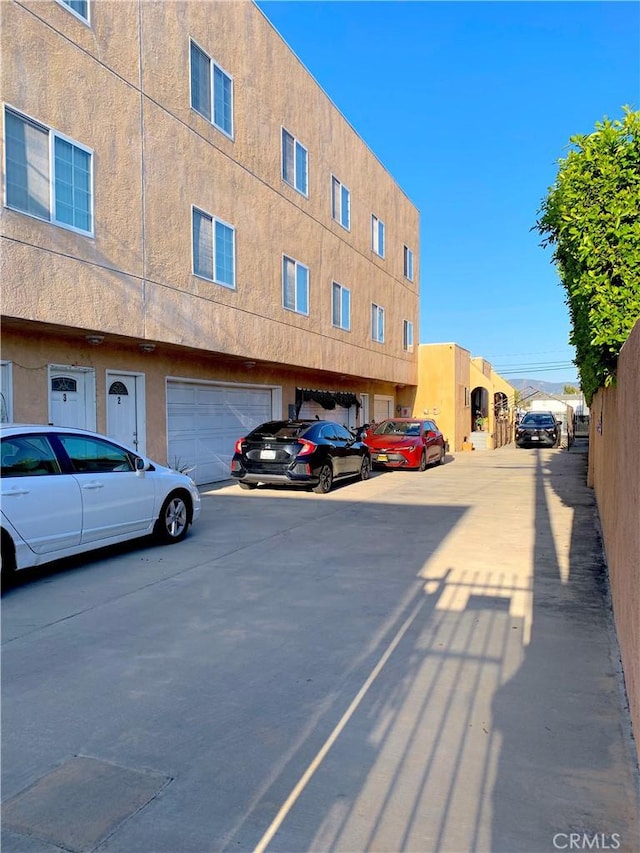 view of car parking featuring a garage