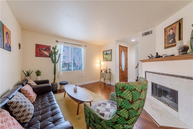 11175 Reagan St, Los Alamitos, CA 90720 - living area with baseboards, visible vents, wood finished floors, and a fireplace