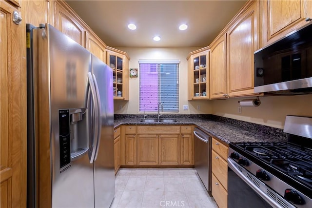11175 Reagan St, Los Alamitos, CA 90720 - kitchen featuring stainless steel appliances, light tile patterned flooring, glass insert cabinets, and a sink