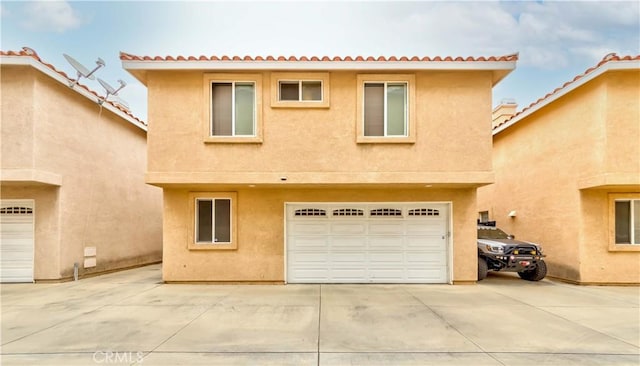 11175 Reagan St, Los Alamitos, CA 90720 - view of front of house featuring concrete driveway, an attached garage, and stucco siding