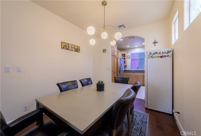 11175 Reagan St, Los Alamitos, CA 90720 - dining area with visible vents, dark wood-style flooring, and a chandelier