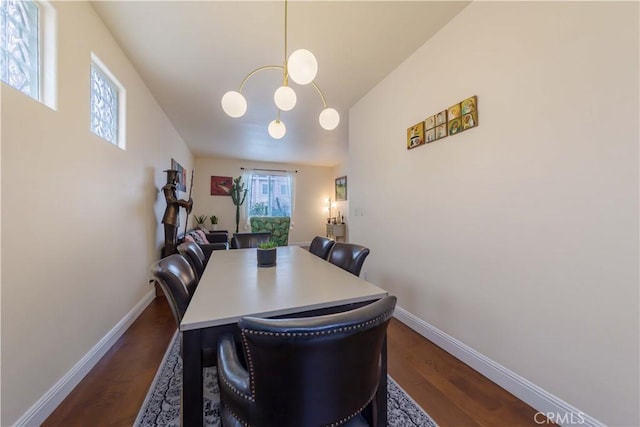 11175 Reagan St, Los Alamitos, CA 90720 - dining area with an inviting chandelier, baseboards, and dark wood-type flooring