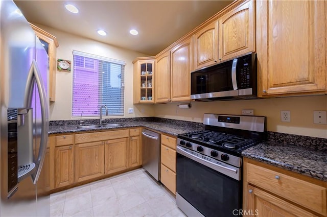 11175 Reagan St, Los Alamitos, CA 90720 - kitchen with a sink, glass insert cabinets, dark stone counters, stainless steel appliances, and recessed lighting