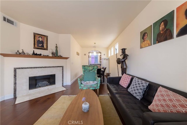 11175 Reagan St, Los Alamitos, CA 90720 - living area featuring visible vents, wood finished floors, a chandelier, and a tile fireplace