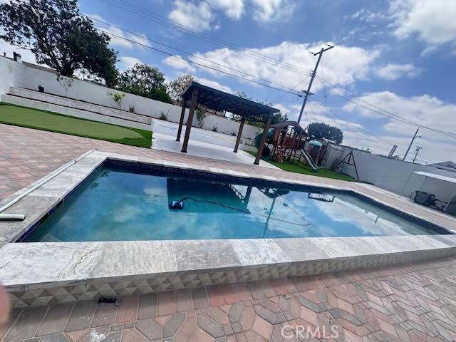 view of pool with a fenced backyard and a patio area